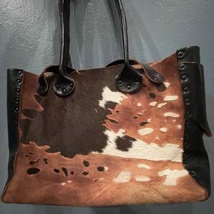 Cow print purse made by Cydmoq.
